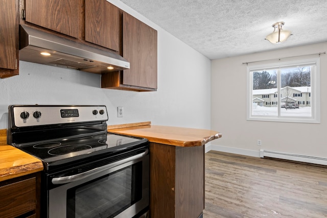 kitchen featuring a textured ceiling, wooden counters, electric range, and under cabinet range hood