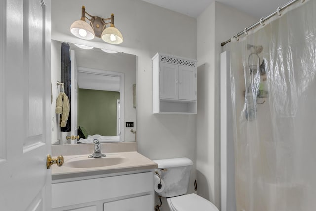 bathroom featuring toilet, a shower with curtain, and vanity