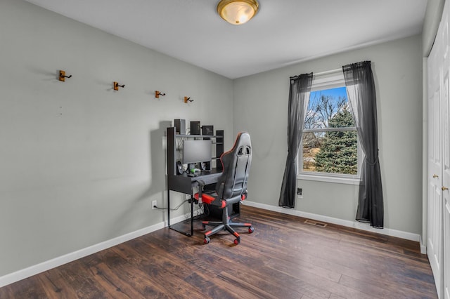 office with visible vents, baseboards, and wood finished floors