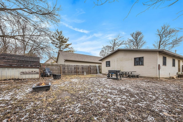 rear view of house featuring fence