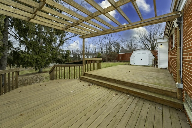 deck featuring a shed, fence, a pergola, and an outdoor structure