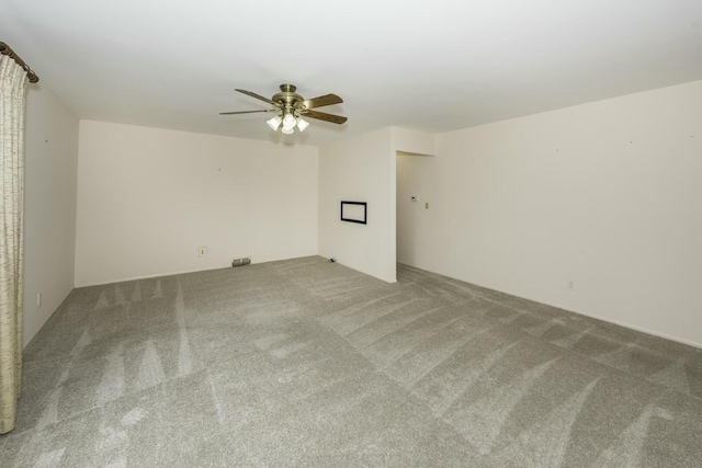 empty room featuring carpet flooring and a ceiling fan