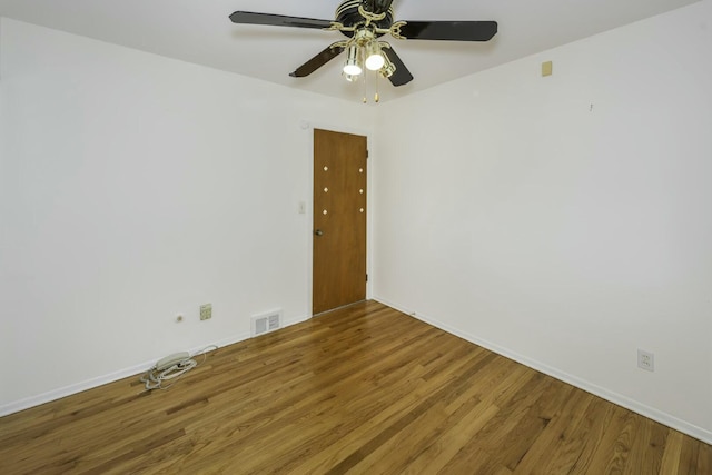 unfurnished room featuring visible vents, ceiling fan, baseboards, and wood finished floors