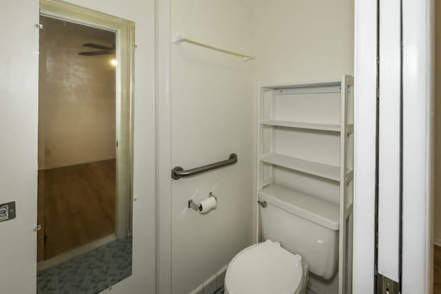 bathroom with toilet and wood finished floors