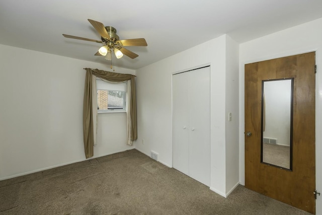 unfurnished bedroom featuring carpet, visible vents, and a closet