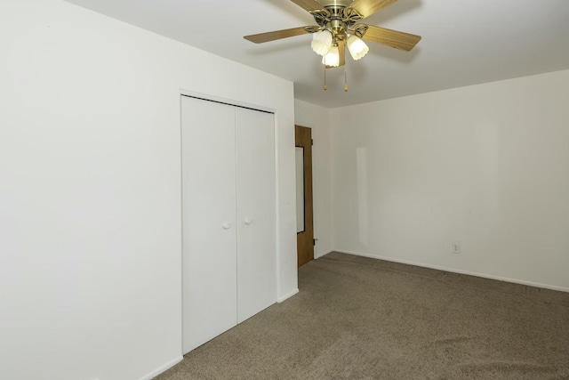 unfurnished bedroom featuring a closet, carpet, a ceiling fan, and baseboards