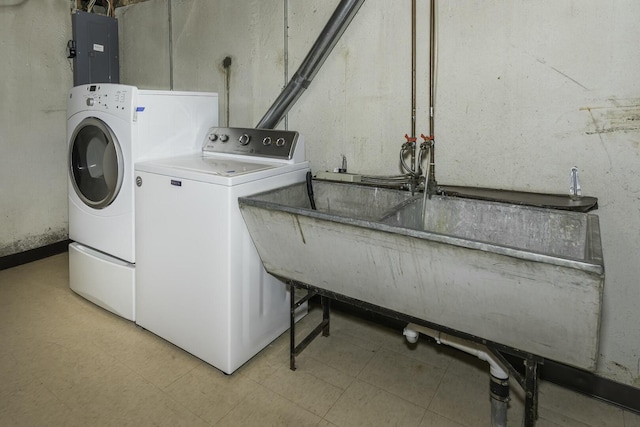 laundry room with laundry area, electric panel, independent washer and dryer, and a sink