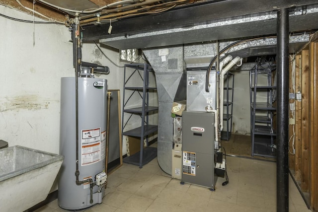 utility room featuring gas water heater, a sink, and heating unit