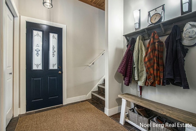 interior space featuring baseboards and stairs