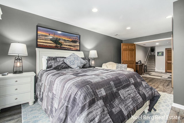 bedroom featuring baseboards, wood finished floors, and recessed lighting