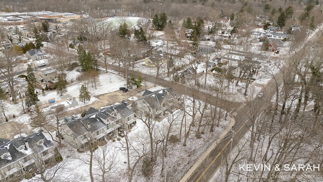 snowy aerial view with a residential view