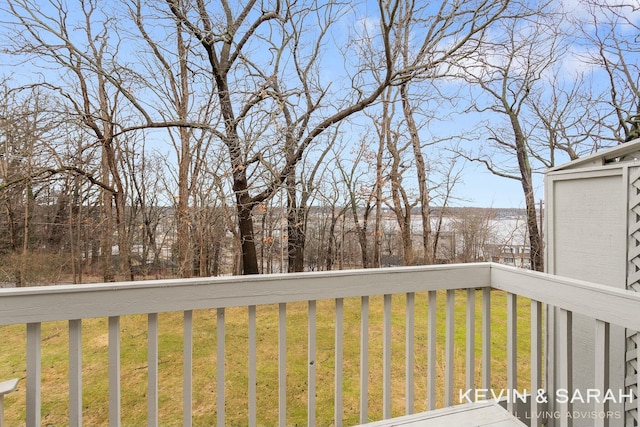 wooden terrace featuring a yard