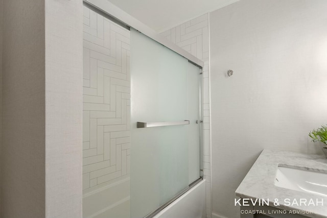 bathroom featuring enclosed tub / shower combo and a sink