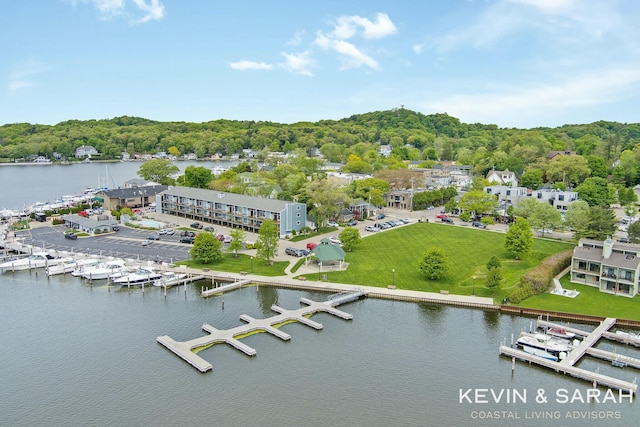 birds eye view of property featuring a water view and a forest view