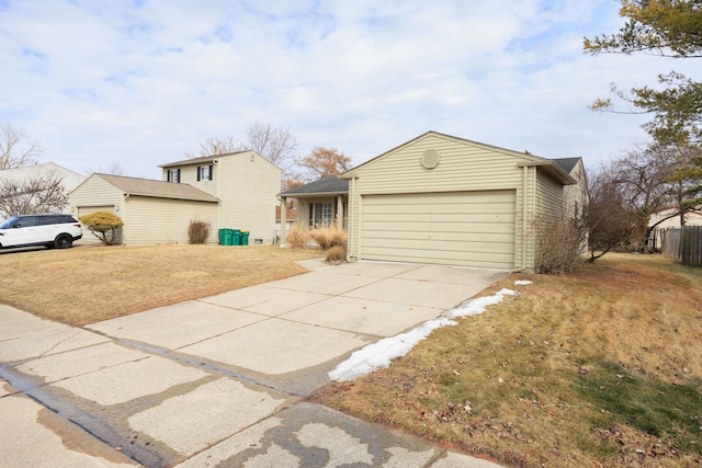 view of front of property featuring concrete driveway and an attached garage