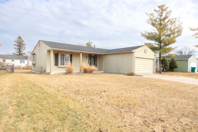 ranch-style home with an attached garage, fence, concrete driveway, and a front yard