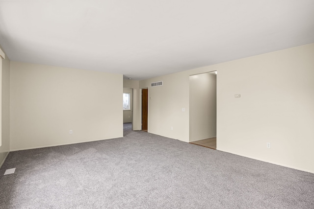 unfurnished room featuring light carpet and visible vents