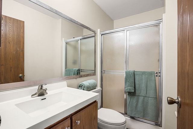 bathroom with a stall shower, vanity, and toilet