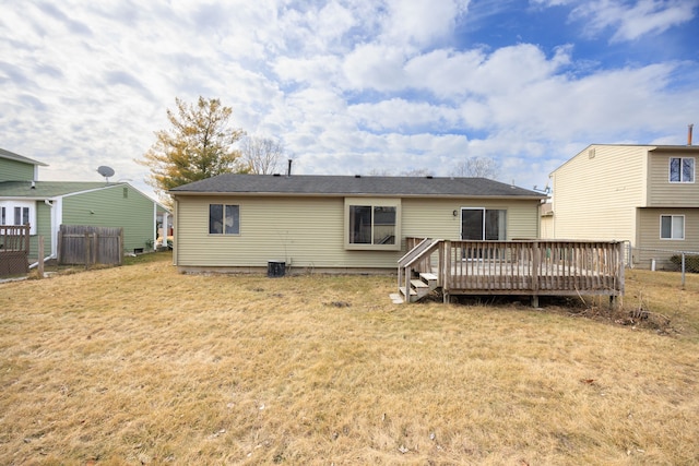 back of house featuring a yard, fence, and a wooden deck