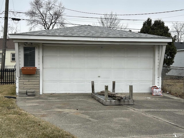 detached garage featuring fence