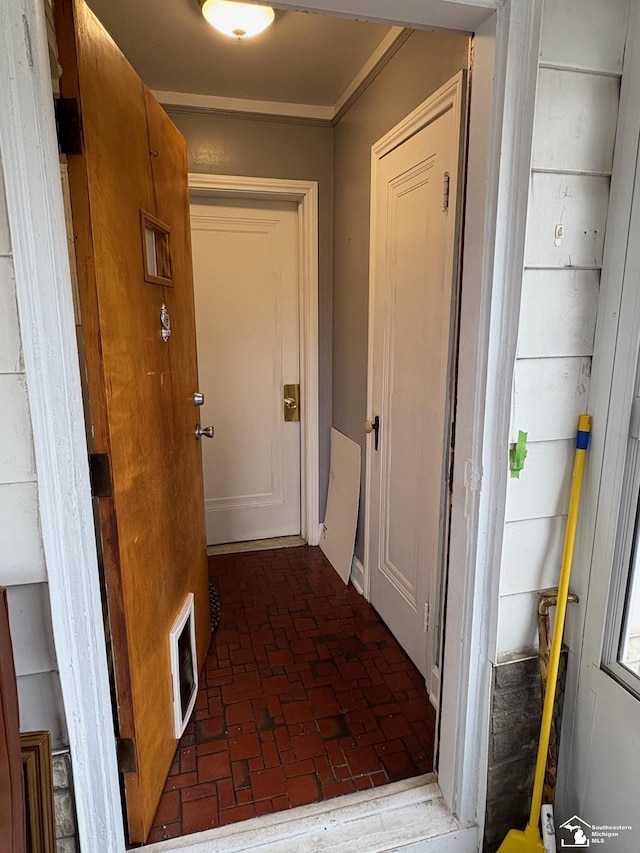 hallway with brick floor and visible vents