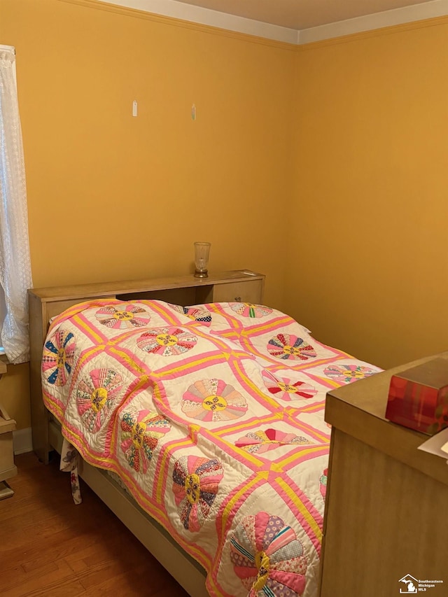 bedroom with wood finished floors