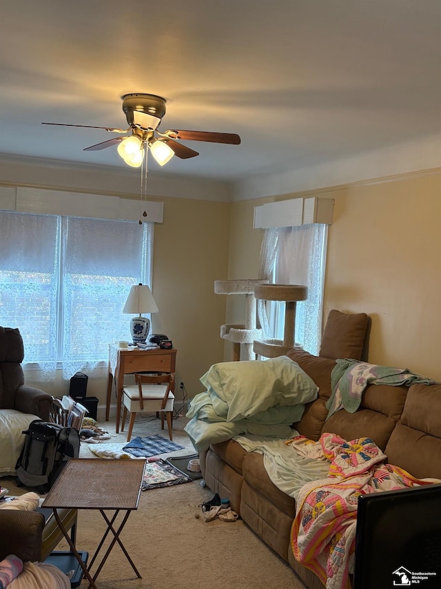 carpeted living room with ceiling fan