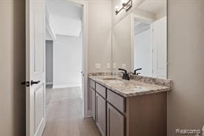 bathroom with vanity and wood finished floors