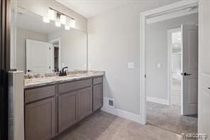 bathroom with vanity and baseboards