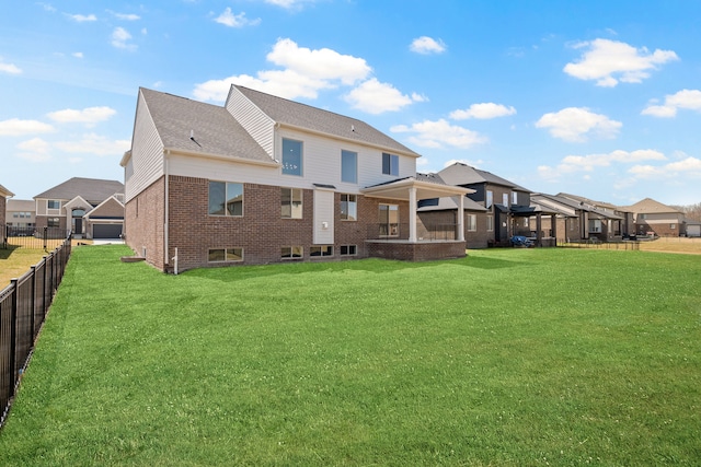 35689 Windridge Dr, New Baltimore, MI 48047 - back of property featuring a yard, brick siding, fence, and a residential view