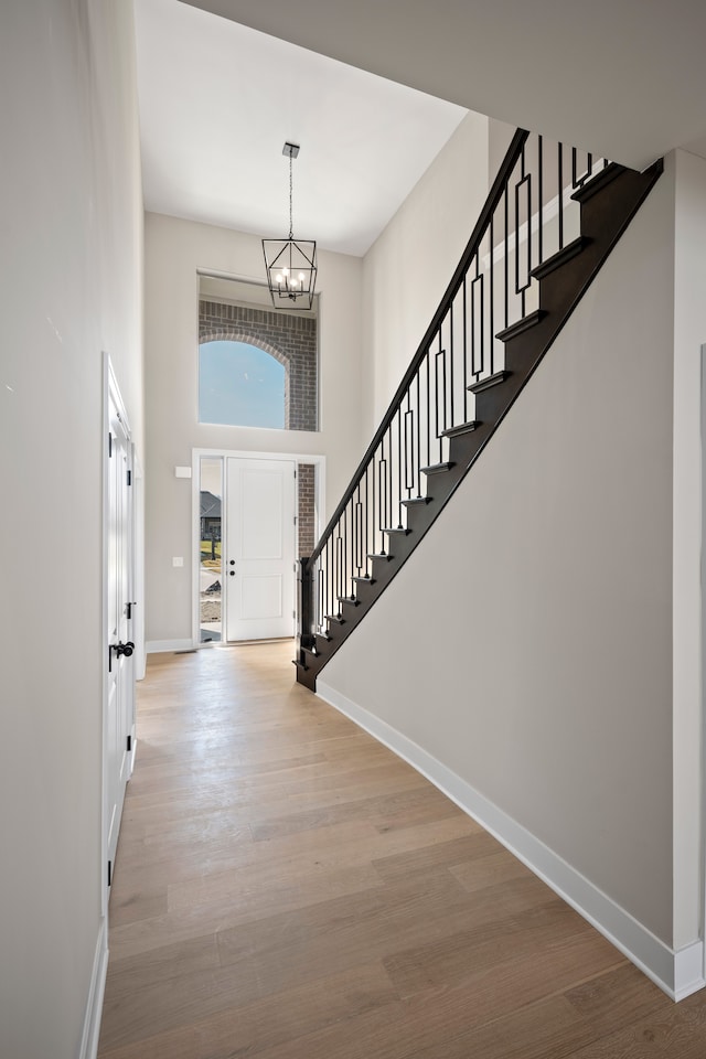 35689 Windridge Dr, New Baltimore, MI 48047 - entrance foyer with stairs, baseboards, an inviting chandelier, and a high ceiling