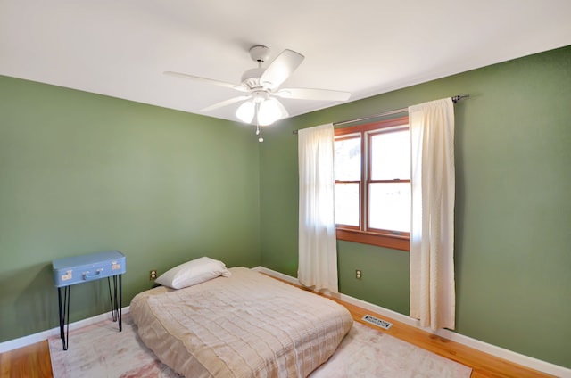 bedroom with baseboards, visible vents, and ceiling fan