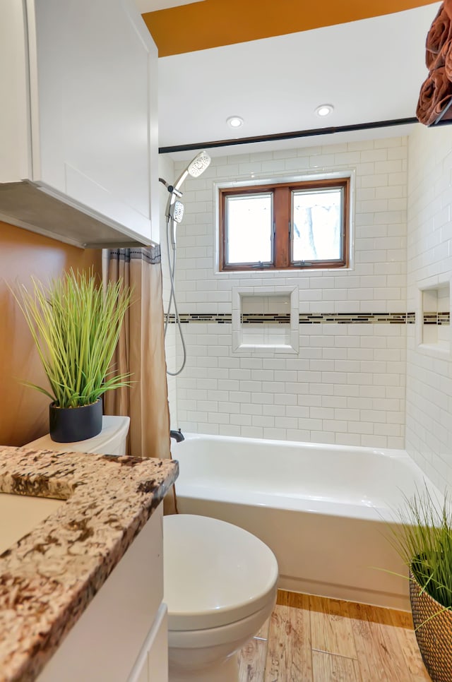 bathroom featuring vanity, wood finished floors, recessed lighting, toilet, and shower / tub combo with curtain