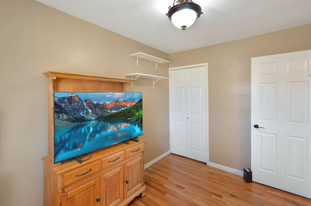 living room featuring baseboards and light wood-style flooring