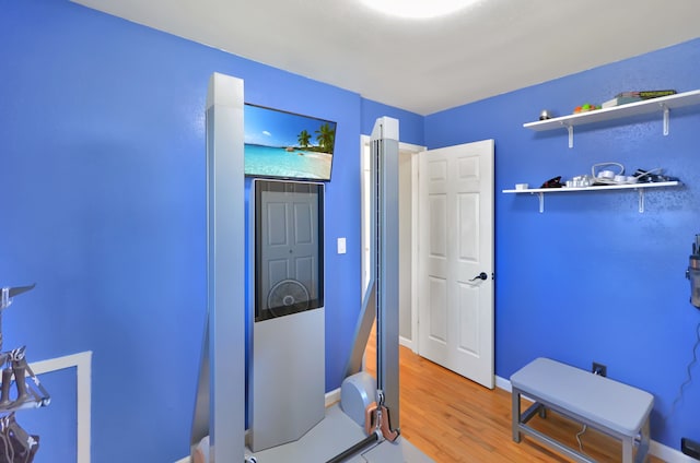 interior space with wood finished floors and baseboards