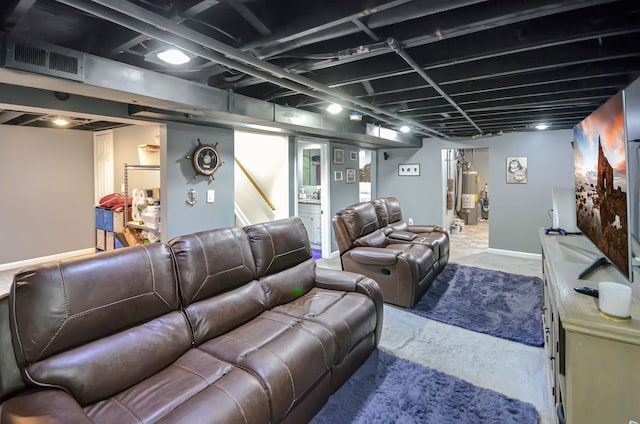 home theater room with visible vents and water heater