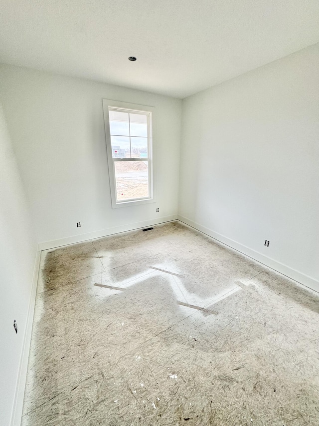 empty room featuring visible vents and baseboards