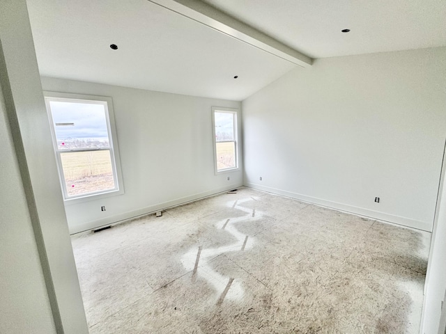 unfurnished room featuring visible vents, vaulted ceiling with beams, and baseboards