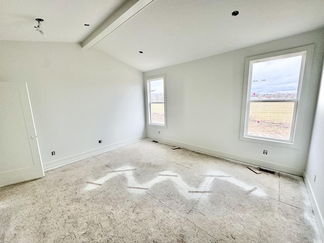 spare room featuring vaulted ceiling with beams and baseboards