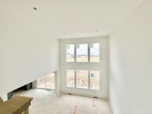 living room featuring a towering ceiling