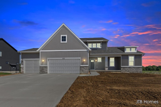 8123 Byron Depot Dr SW, Byron Center, MI 49315 - craftsman-style home with stone siding, driveway, a garage, a shingled roof, and board and batten siding