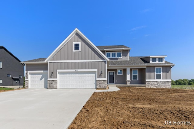 8123 Byron Depot Dr SW, Byron Center, MI 49315 - craftsman-style home featuring stone siding, concrete driveway, an attached garage, roof with shingles, and board and batten siding