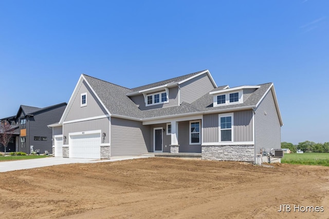 8123 Byron Depot Dr SW, Byron Center, MI 49315 - craftsman inspired home with stone siding, concrete driveway, cooling unit, an attached garage, and roof with shingles