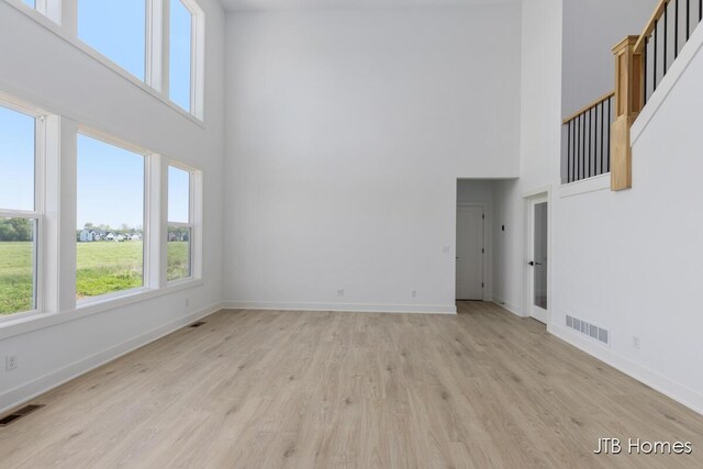 8123 Byron Depot Dr SW, Byron Center, MI 49315 - spare room with a high ceiling, healthy amount of natural light, and baseboards