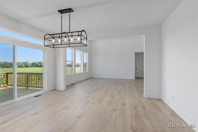 8123 Byron Depot Dr SW, Byron Center, MI 49315 - unfurnished dining area with a chandelier, baseboards, and wood finished floors