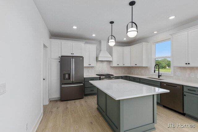 8123 Byron Depot Dr SW, Byron Center, MI 49315 - kitchen featuring stainless steel appliances, a sink, premium range hood, white cabinets, and tasteful backsplash