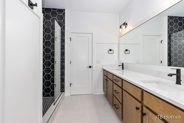 8123 Byron Depot Dr SW, Byron Center, MI 49315 - bathroom with a shower stall, double vanity, and tile patterned floors