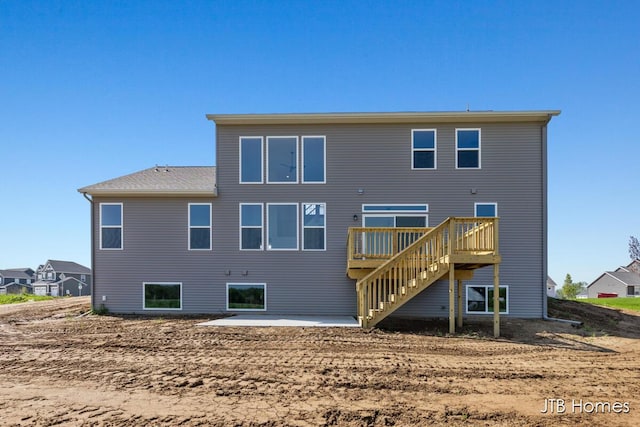 8123 Byron Depot Dr SW, Byron Center, MI 49315 - back of house featuring stairway, a wooden deck, and a patio