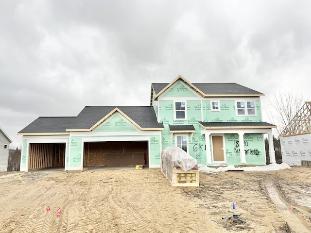 property in mid-construction with dirt driveway and an attached garage