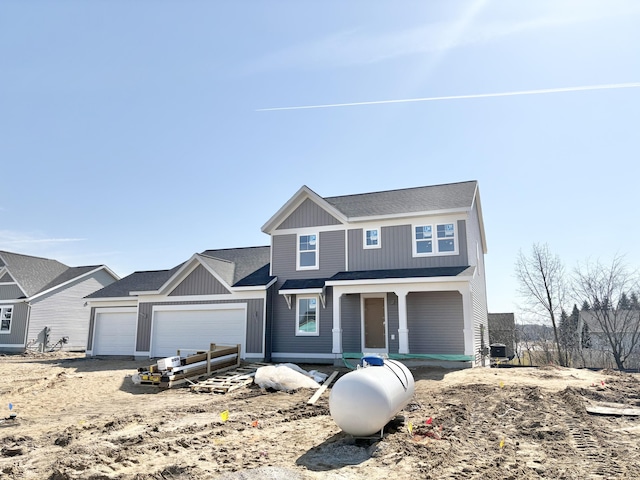 view of front of property featuring central AC unit, an attached garage, and a shingled roof